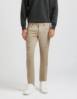 Pantaloni cinque tasche in cotone con strappi